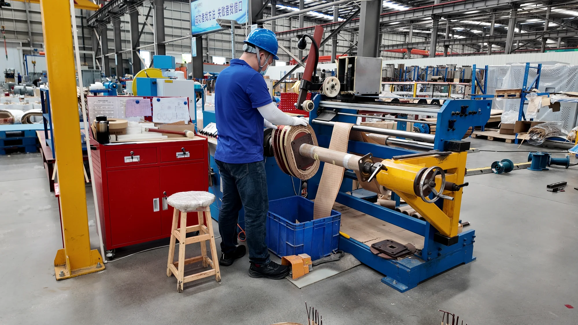 Technician operating transformer winding equipment